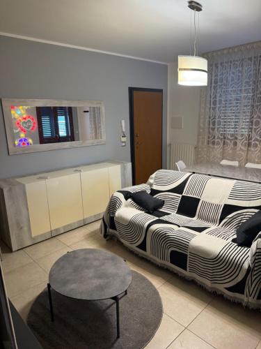 a bedroom with two beds and a table in it at Illumina House 2 in Giurdignano