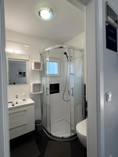 a bathroom with a shower and a sink at Matea in Plomin