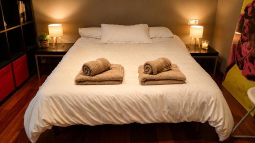 a bedroom with a large bed with towels on it at Unique and special loft in Sant Joan de les Abadesses