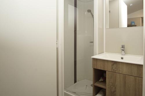 a bathroom with a sink and a toilet at Tiny Chalet Nr 819 in Göhren