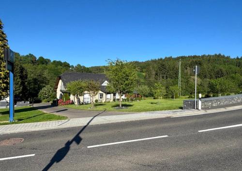 a shadow of a street sign on the side of a road at Appartment Haus Müller in Kelberg
