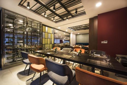 a dining room with a long table and chairs at Novotel Suites Hanoi in Hanoi
