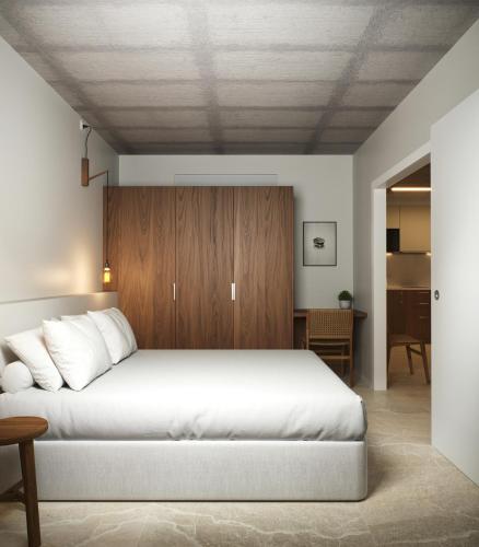 a bedroom with a large bed with a wooden headboard at Apartamentos Turísticos A Mariña Do Carril in Vilagarcia de Arousa