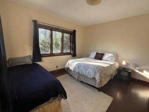 a bedroom with a bed and a window at Mountain Modern 4 Bedroom Cabin on Hiking Trails in Fairplay