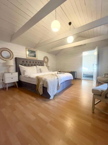 a bedroom with a bed and a wooden floor at Brightside House in Kristiansand