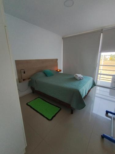 a bedroom with a green bed and a window at SAN jose in Federación