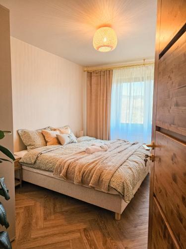 a bedroom with a bed and a window at Check in Silence in Tylicz
