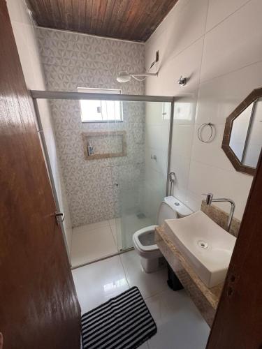 a bathroom with a shower and a toilet and a sink at Palmeira House in Formosa
