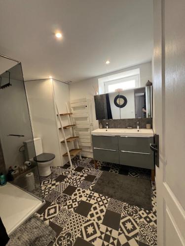 a bathroom with a tub and a sink and a mirror at L'Annexe du Piton in Sancerre