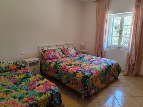 a bedroom with two beds and a window at Reale Home in Casa Tonietti