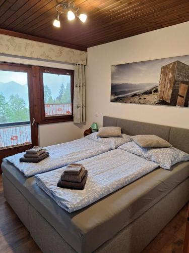 a bedroom with a large bed with towels on it at Haus Alexander in Fresach
