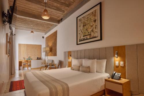 a bedroom with a bed with a phone on a table at Casa Carmen Morelos in Oaxaca City