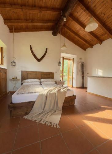 a bedroom with a bed in a room with wooden ceilings at Casa Antonietta in Domaso