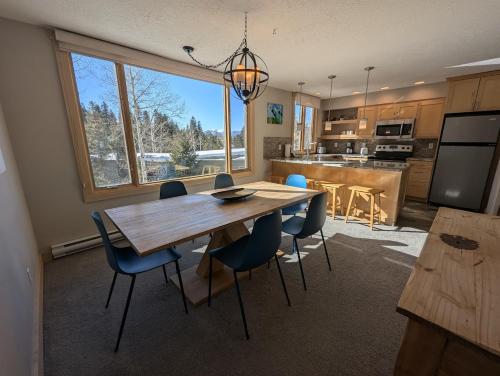 a kitchen with a large wooden table and chairs at Argentine 1516 by SummitCove Lodging in Colorado in Keystone