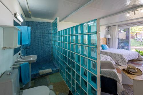 a bathroom with a blue tiled wall next to a bedroom at Jacaranda in Cádiz