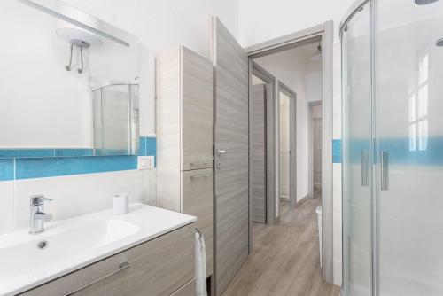 a bathroom with a sink and a shower at Domu Fama in Tertenìa