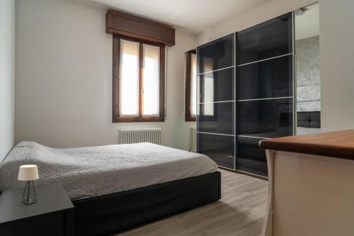 a bedroom with a bed and a glass shower at Emilia Suite Space in Modena
