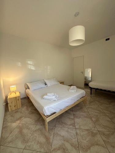 a bedroom with a bed with two towels on it at La Casa di Aira in Martina Franca