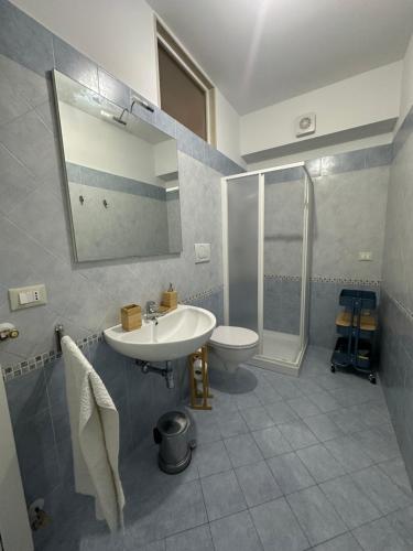 a bathroom with a sink and a shower and a toilet at La Casa di Aira in Martina Franca