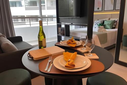 a dining table with a bottle of wine and glasses at Estadia Sampa Butantã in São Paulo