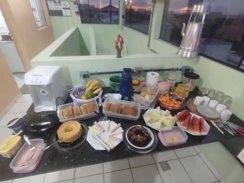 a table with many different food items on it at Pousada Sevilha in Sumaré