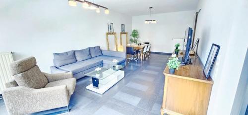 a living room with a couch and a table at Central Luxembourg Stay-2BR in Hollerich