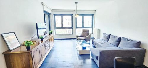 a living room with a couch and a table at Central Luxembourg Stay-2BR in Hollerich