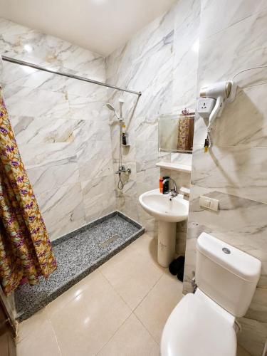 a bathroom with a toilet and a sink and a shower at Tiba Golden beach resort hurghada down town in Hurghada