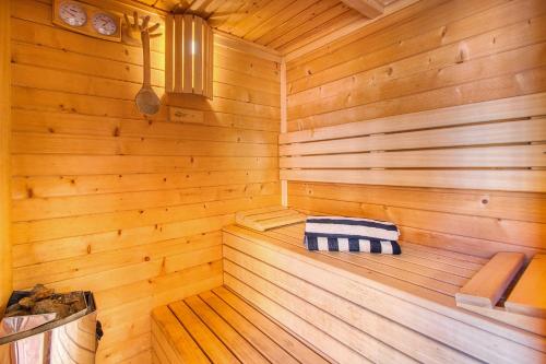 a wooden sauna with a blue and white towel at 4BR Wellness Villa- Pool, Sauna, Gym in Puerto de la Cruz