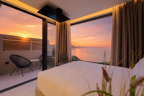 a bedroom with a bed and a view of the ocean at Palms and Spas Villas Retreat in Mesongi