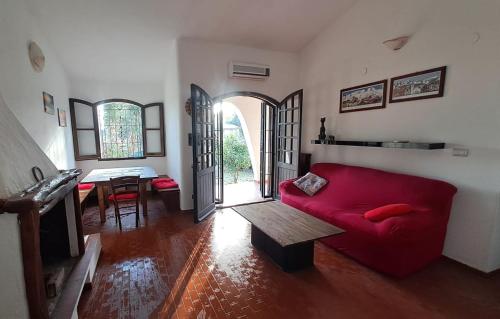 a living room with a red couch and a table at Casa Sofia in Torre delle Stelle