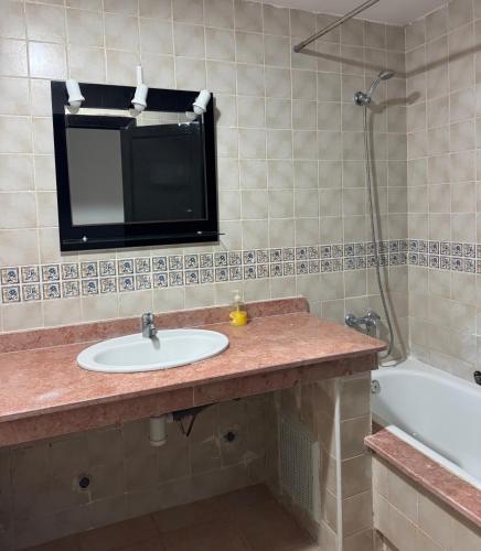 a bathroom with a sink and a bath tub at Saidia Marina in Saïdia