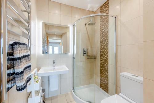 a bathroom with a glass shower and a sink at 2 Bed in Torcross oc-bcatbe in Torcross