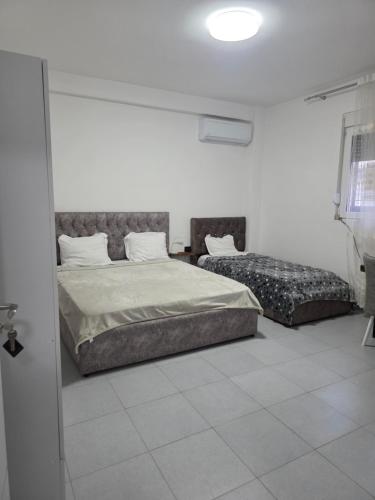 a white room with a bed and a couch at Casa Del Sol Pogradec in Pogradec