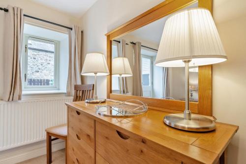 a desk with two lamps and a mirror at 3 Bed in Bishop Auckland oc-36671 in Wolsingham