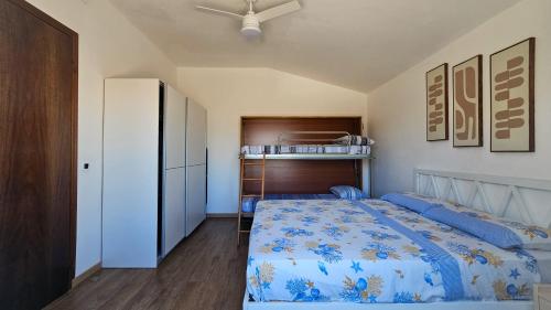 a bedroom with a blue bed and a closet at Residenza Tulipano in Eraclea Mare