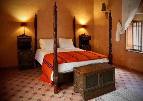 a bedroom with a four poster bed in a room at Riad Azula in Salé