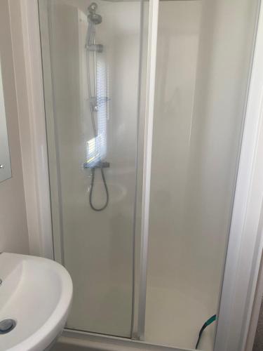 a bathroom with a shower and a sink at Aqua bay whistable in Swalecliffe