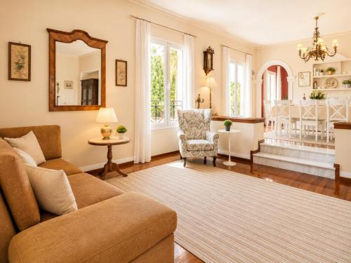 a living room with a couch and a mirror at Villa Golden Tiara Large Private Pool AC WiFi in Corfu