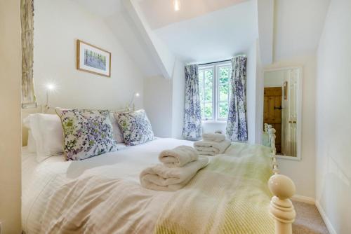 a bedroom with a white bed with towels on it at 2 Bed in Looe oc-l30015 in Lansallos