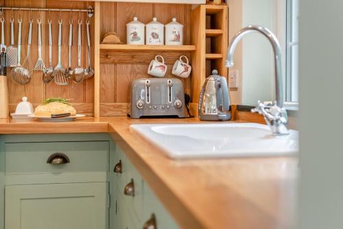a kitchen with a sink and a counter top with a sink at 2 Bed in Looe oc-l30015 in Lansallos