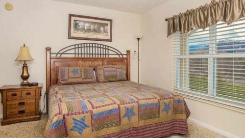 a bedroom with a bed and a window at WP651 Smokin' Views Penthouse in Pigeon Forge