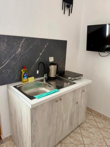 a kitchen counter with a sink and a stove at VIOLA Seaside Villa in Ksamil
