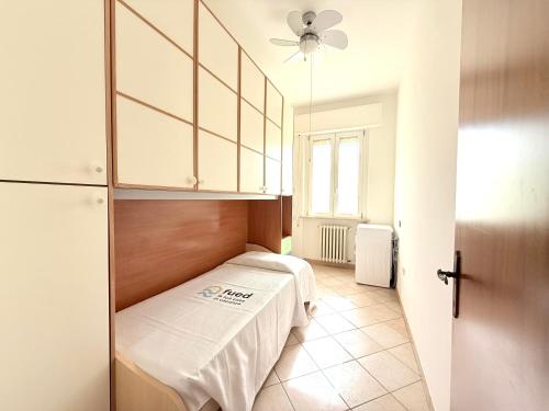 a small room with a bed and a ceiling fan at SE238 - Marotta, quadrilocale con corte privata in Marotta