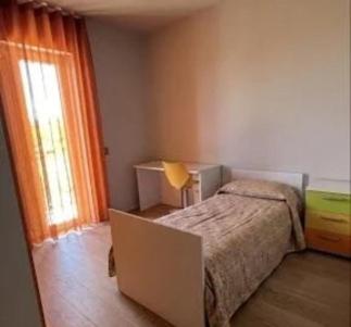 a small bedroom with a bed and a window at Suite del Colonnello B&b in Rionero in Vulture