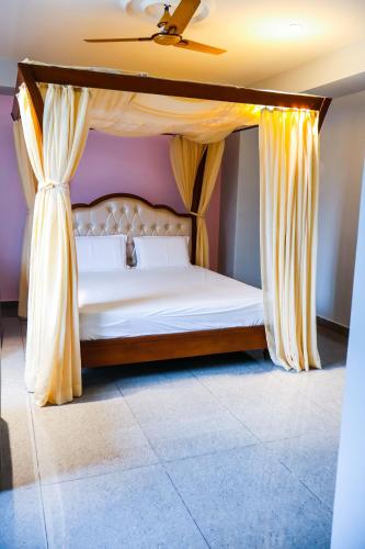 a bed with a canopy in a room at Shree Priyam Residency in Rāmanāthapuram