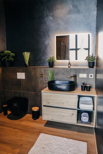 a bathroom with a sink and a mirror at Ascent Lodge -Jacuzzi si Panoramic View in Petreasa