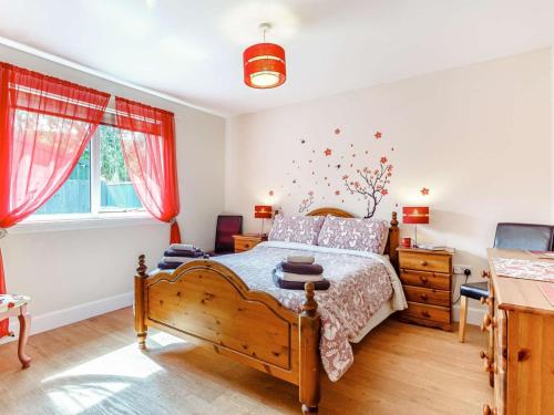 a bedroom with a wooden bed and a wooden dresser at 2 Bed in Inverness oc-44481 in Drumnadrochit