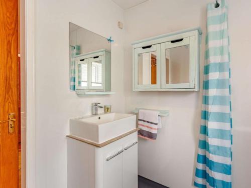 a white bathroom with a sink and a mirror at 2 Bed in Inverness oc-44481 in Drumnadrochit