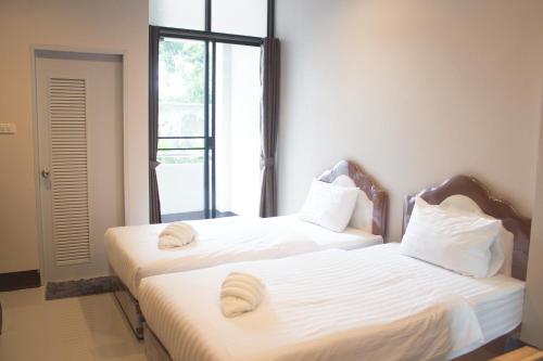 Ένα ή περισσότερα κρεβάτια σε δωμάτιο στο Naiya Place